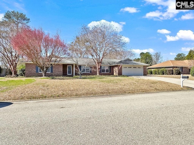 ranch-style home with a garage, driveway, brick siding, and a front lawn