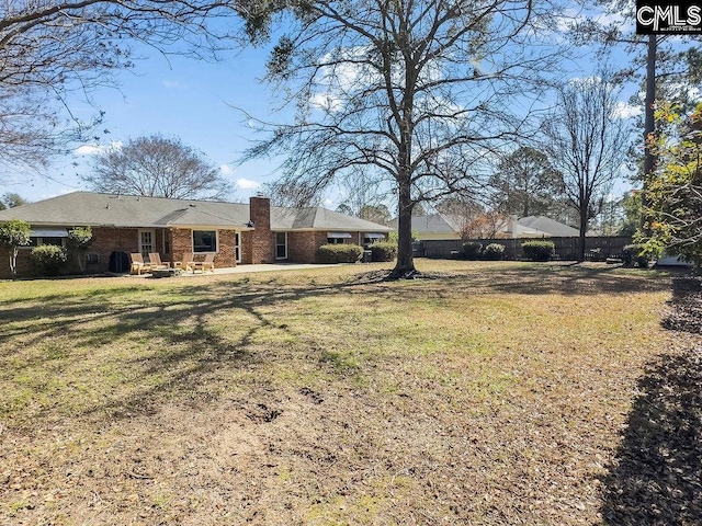 view of yard with fence and a patio