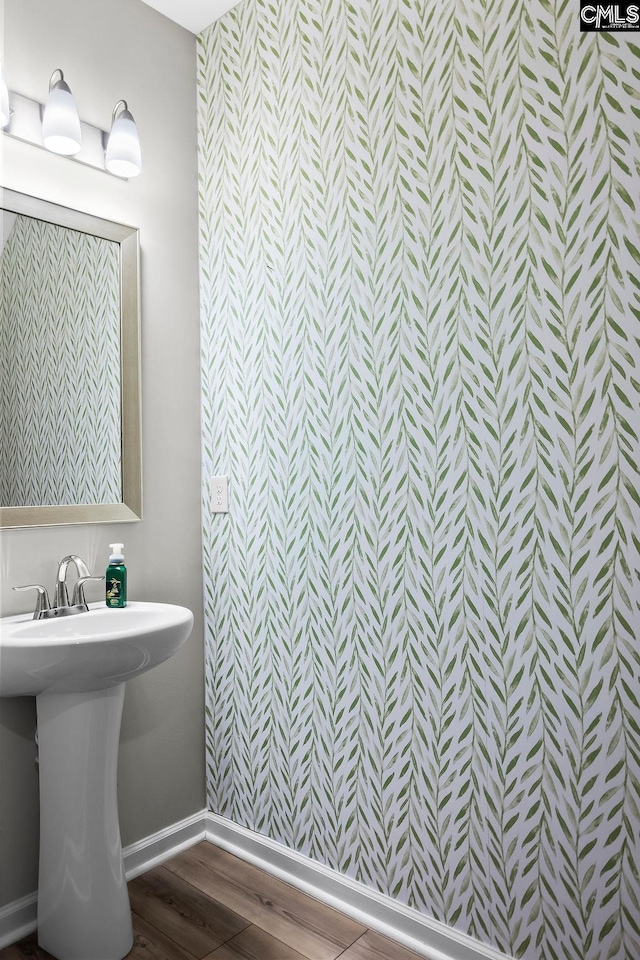 bathroom with baseboards and wood finished floors