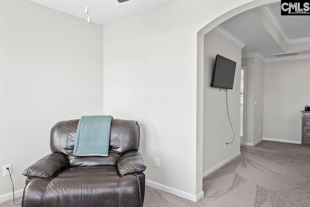 living area featuring light carpet, baseboards, visible vents, arched walkways, and ornamental molding