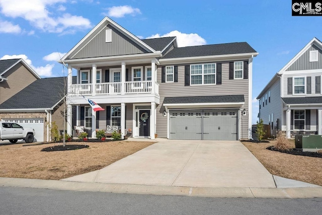 view of front of home with a garage, driveway, a porch, and a balcony