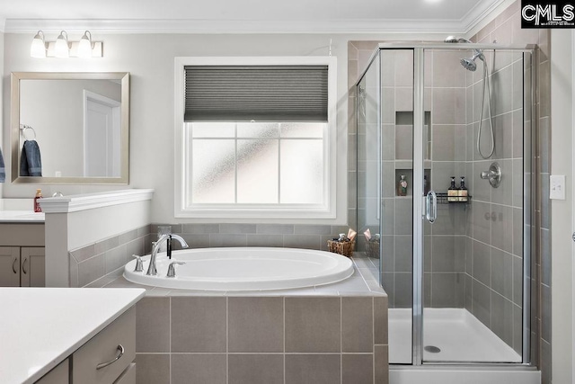 bathroom featuring a stall shower, a garden tub, crown molding, and vanity