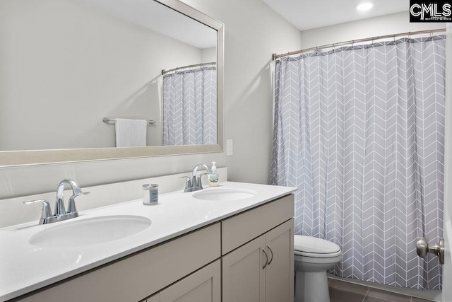 full bathroom featuring double vanity, a sink, and a shower with shower curtain