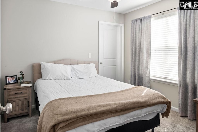 carpeted bedroom with multiple windows and baseboards