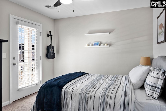 carpeted bedroom featuring ceiling fan and visible vents