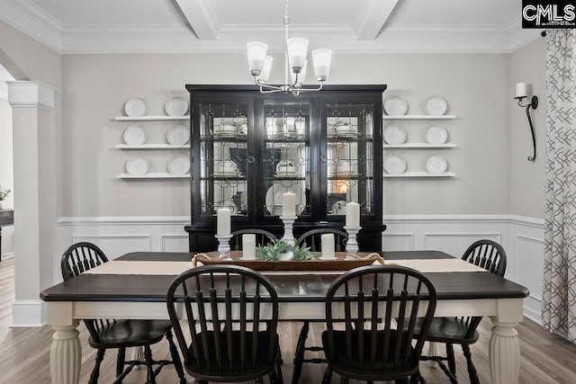 dining area with a chandelier, arched walkways, wood finished floors, and beam ceiling