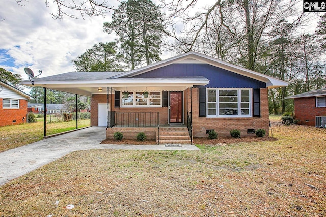 view of front of house featuring brick siding, concrete driveway, crawl space, a carport, and a front lawn