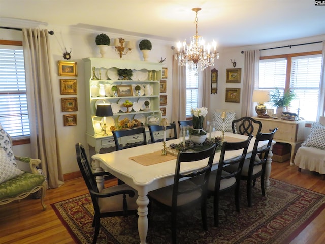 dining area featuring an inviting chandelier and wood finished floors