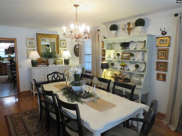 dining area featuring baseboards, dark wood-style flooring, an inviting chandelier, and crown molding