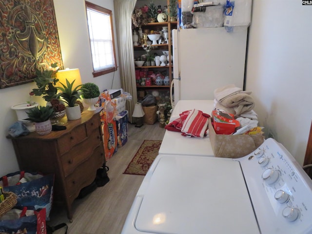 laundry area featuring washer / dryer, light wood-style flooring, and laundry area