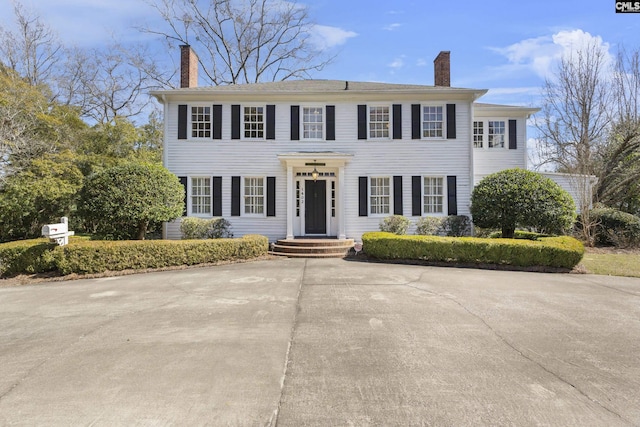 colonial inspired home featuring a chimney