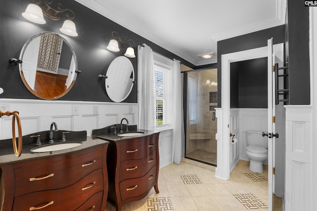 full bathroom with crown molding, two vanities, a sink, and a shower stall