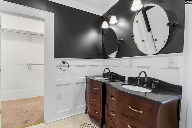 bathroom featuring ornamental molding, two vanities, a sink, and tile patterned floors