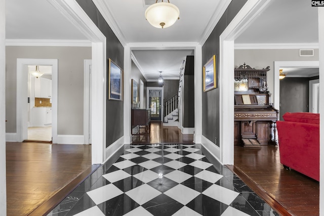 hall with ornamental molding, visible vents, stairway, and baseboards