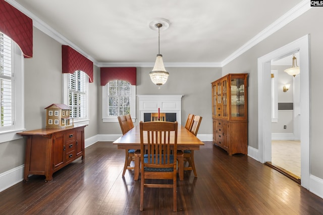 dining room with baseboards, dark wood-type flooring, and crown molding