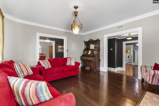 living room with dark wood-style floors, ornamental molding, independent washer and dryer, and visible vents