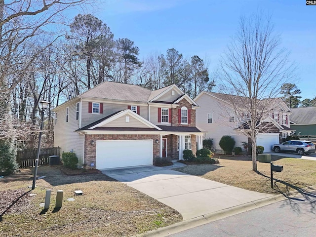 traditional home with a garage, driveway, cooling unit, and fence