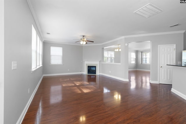 unfurnished living room with a fireplace with flush hearth, ornamental molding, dark wood finished floors, and visible vents