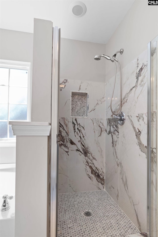 full bath featuring a marble finish shower