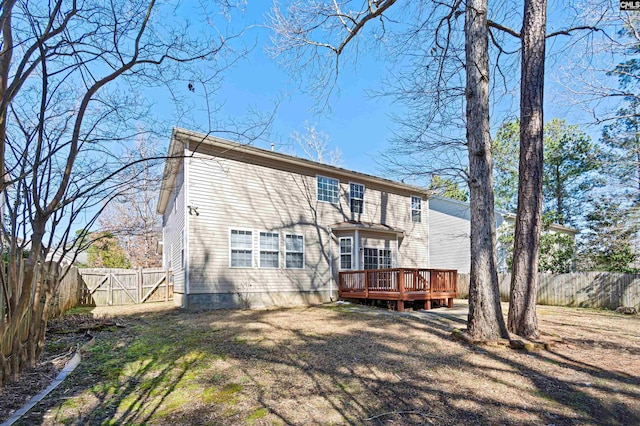 rear view of house with a yard, a fenced backyard, and a wooden deck