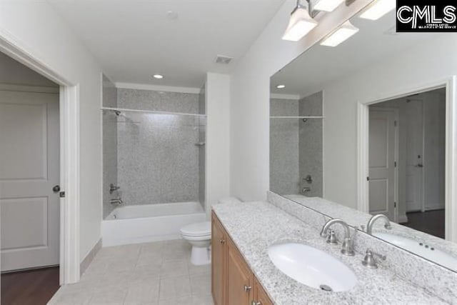 bathroom featuring visible vents, toilet, washtub / shower combination, vanity, and tile patterned floors