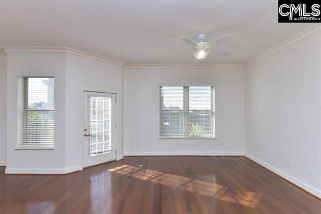 interior space featuring baseboards, plenty of natural light, ornamental molding, and dark wood-style flooring