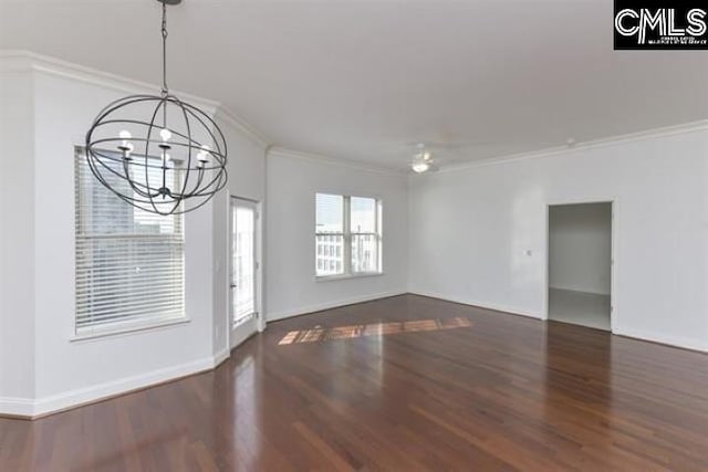 unfurnished room featuring ornamental molding, dark wood finished floors, a notable chandelier, and baseboards