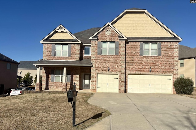 craftsman house with an attached garage, concrete driveway, and brick siding