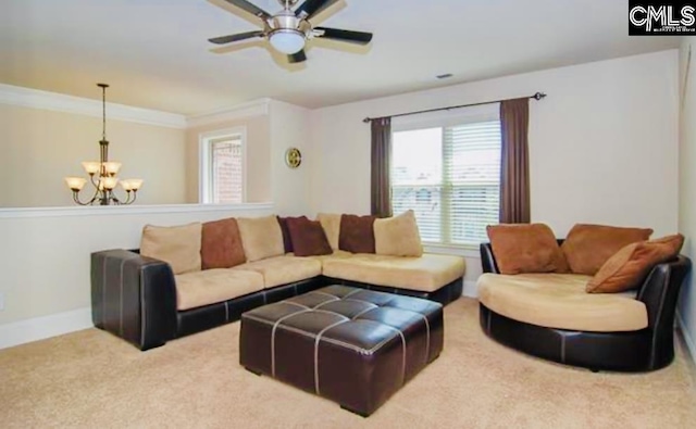 living room featuring light carpet, crown molding, baseboards, and ceiling fan with notable chandelier