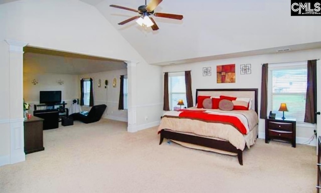 carpeted bedroom with baseboards, high vaulted ceiling, a ceiling fan, and ornate columns