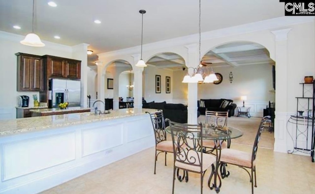 dining area featuring arched walkways, crown molding, recessed lighting, a decorative wall, and coffered ceiling