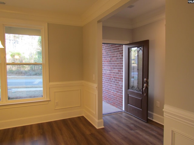 entryway with a decorative wall, baseboards, wainscoting, dark wood-style floors, and crown molding