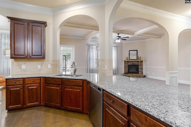 kitchen with coffered ceiling, dishwasher, light stone counters, dark wood-type flooring, and a sink