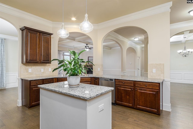 kitchen with coffered ceiling, dishwasher, a peninsula, light stone countertops, and a decorative wall