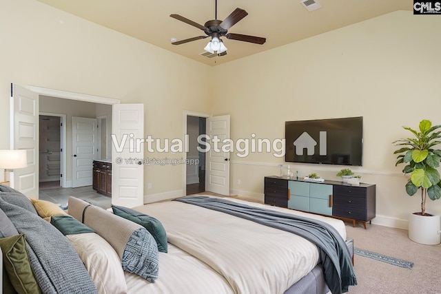 bedroom with high vaulted ceiling, connected bathroom, light colored carpet, visible vents, and baseboards