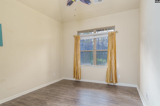 empty room featuring visible vents, baseboards, ceiling fan, and wood finished floors