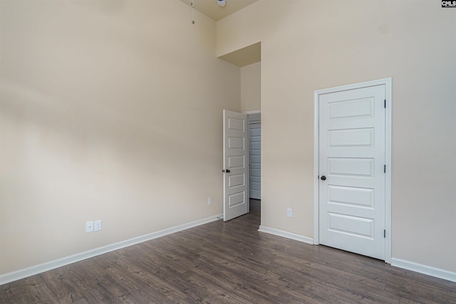 unfurnished bedroom featuring dark wood-style floors and baseboards