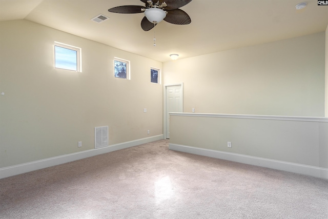 unfurnished room featuring light colored carpet, visible vents, ceiling fan, and baseboards