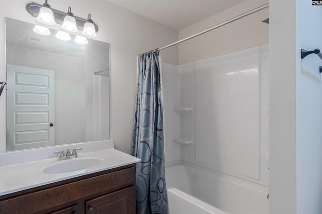 bathroom with shower / tub combo and vanity