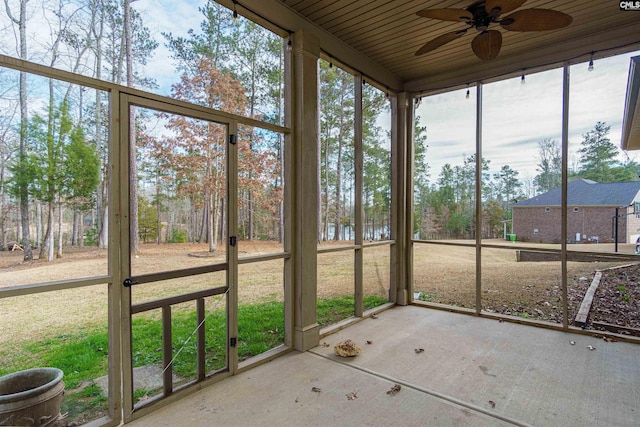 unfurnished sunroom with ceiling fan