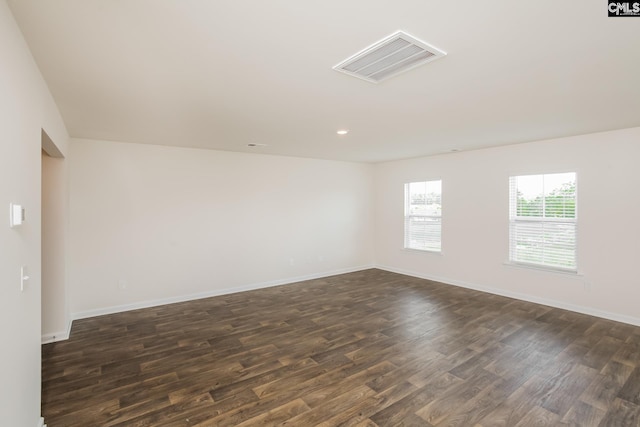 unfurnished room with recessed lighting, dark wood-style flooring, visible vents, and baseboards