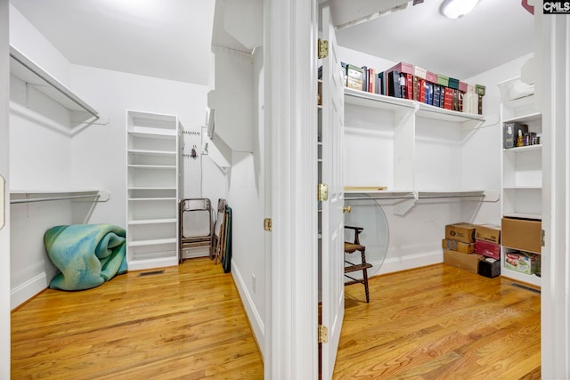 walk in closet with visible vents and light wood finished floors