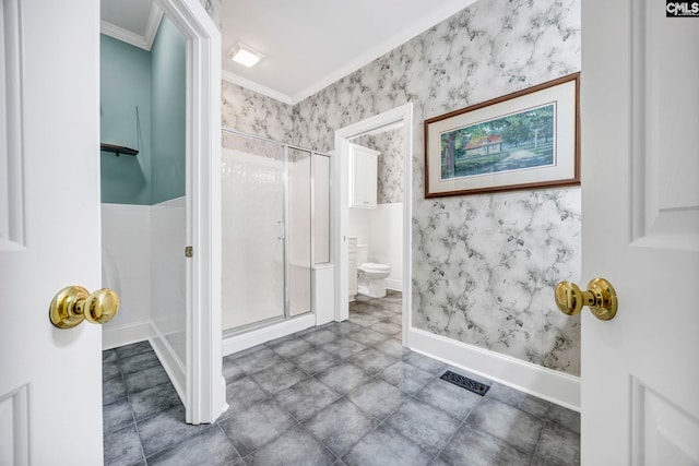 bathroom featuring a stall shower, crown molding, toilet, and wallpapered walls