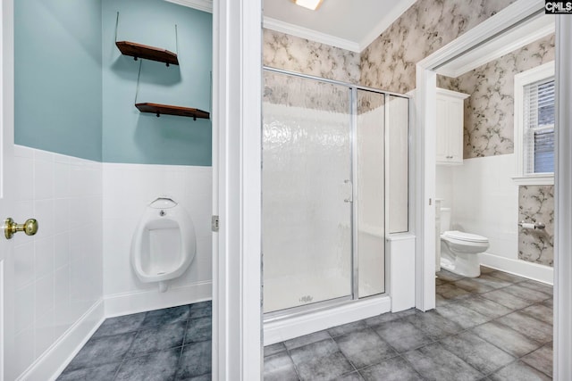 bathroom featuring a wainscoted wall, tile walls, toilet, a stall shower, and wallpapered walls