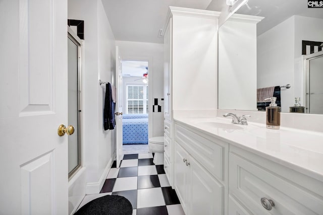 ensuite bathroom with toilet, combined bath / shower with glass door, vanity, ensuite bath, and tile patterned floors