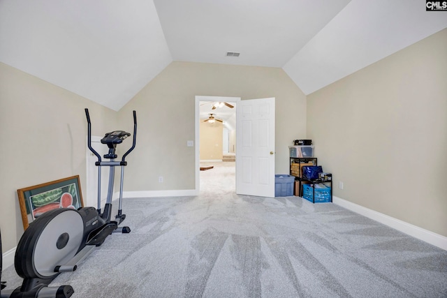 workout area with lofted ceiling, visible vents, light carpet, and baseboards