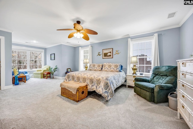 bedroom featuring multiple windows, visible vents, crown molding, and light colored carpet