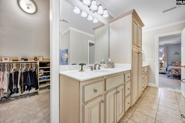 ensuite bathroom featuring tile patterned floors, visible vents, ornamental molding, and ensuite bathroom