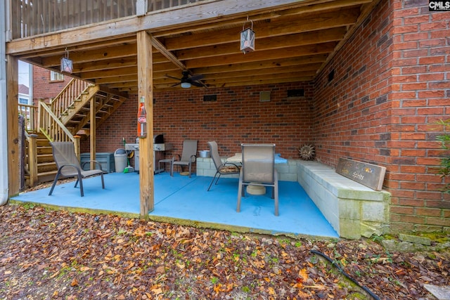 view of patio with stairway and a ceiling fan