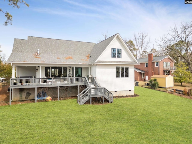 rear view of property featuring an outbuilding, a yard, stairway, a storage shed, and crawl space